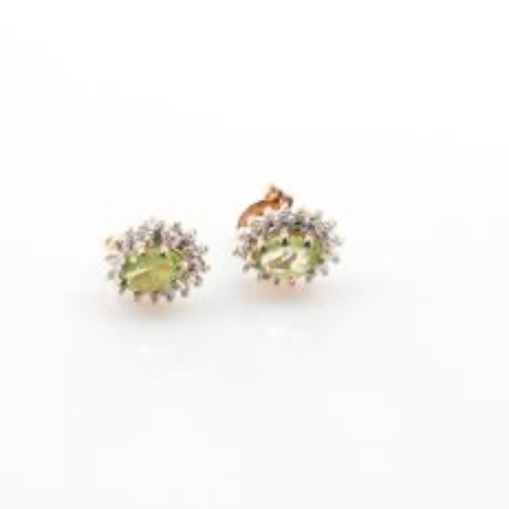 Sterling silver stud earrings with green stone in prong setting marked 925
